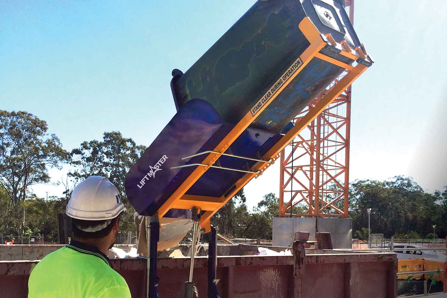 The Liftmaster Rugged powered bin lifter on a construction site 